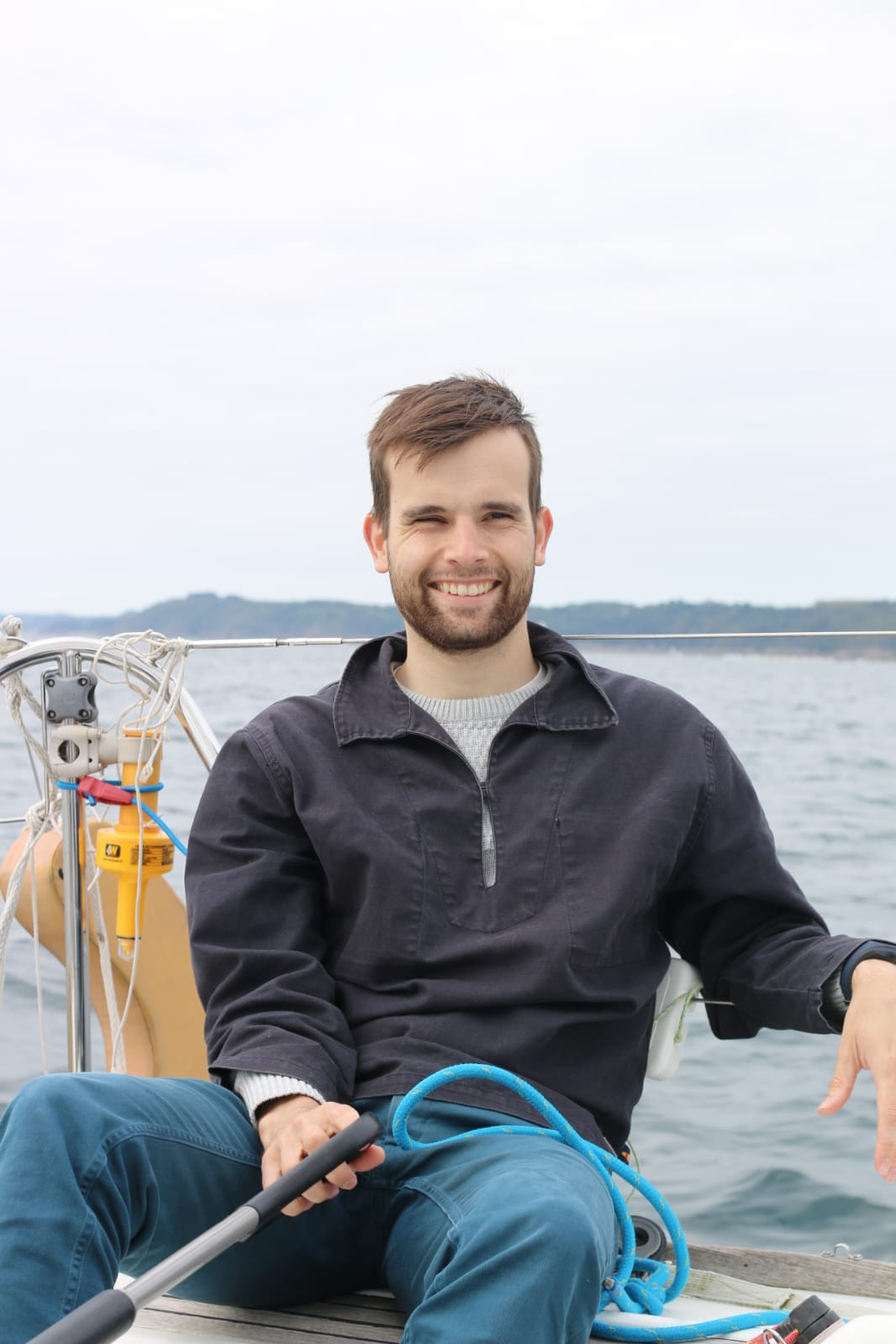 Young man sailing off the coast of northern Brittany.